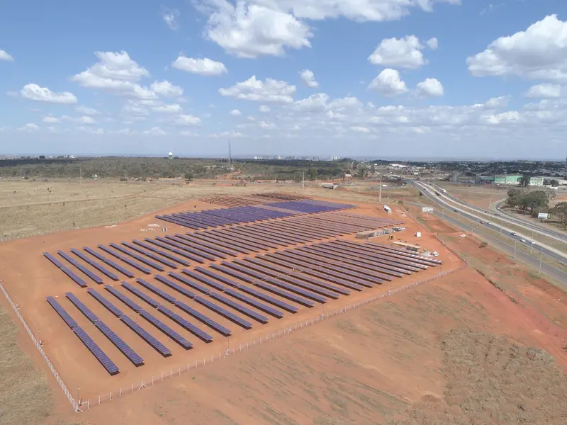 Usina solar vista do alto em um terreno de terra vermelha